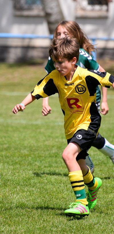 Boy takes on the football at a Ball Friends tournament