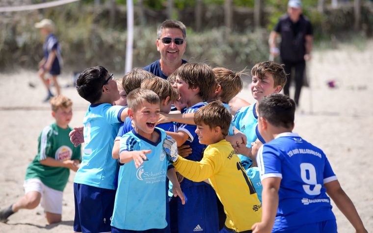 Des enfants en liesse lors d'un tournoi de beach soccer sur la mer Baltique.